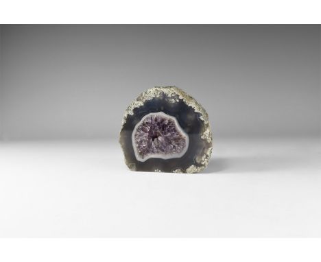 An agate geode filled with purple amethyst crystals. 946 grams, 10.3cm (4"). From the historic ‘Victorian Museum’ and later c