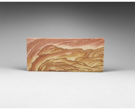 A fine cut block of a sandstone with bands of red and orange creating a 'landscape' image. 724 grams, 11 x 26cm (4 1/4 x 10 1