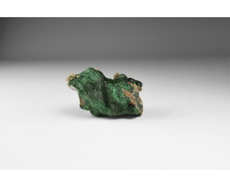 A deep green crystalline malachite specimen in white card tray with label reading: 'MALACHITE (Crystalline), D.R.Congo'. 121 
