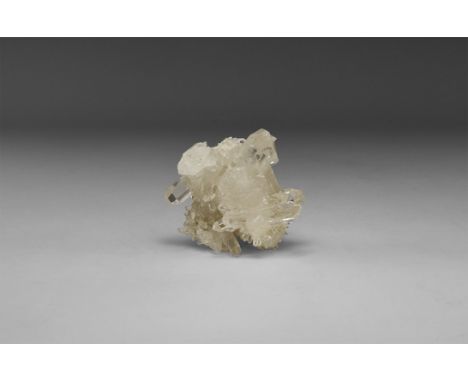 A grouping of transparent quartz crystals in a white card tray with label reading: 'Quartz, Corinto, Minas Gerais, Brazil'. 1