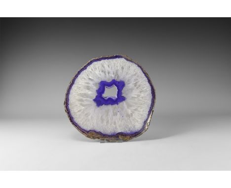 A large cut and polished agate slice with violet colour and honeycomb crystal sections, colour enhanced. 706 grams, 22cm (8 1