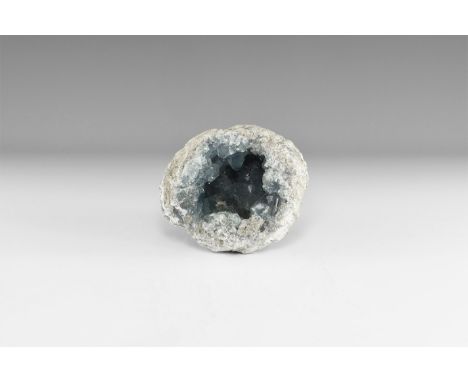 A large geode with clusters of large celestine crystals in a pale blue with rainbow reflections. 2.54 kg, 14cm (5 1/2"). From
