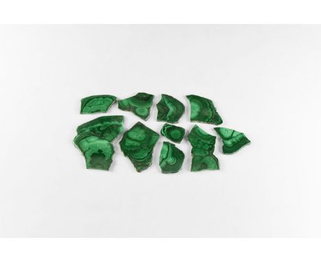 A group of ten cut and polished slices of malachite, approximately 3mm thick, with pale and dark green banding. 185 grams tot