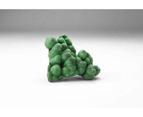 A very fine specimen of deep green crystalline malachite in white card tray with label reading: 'CRYSTALLINE MALACHITE, D.R.C
