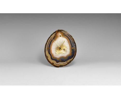 A large agate slice with bands of blue, orange and brown, small cluster of quartz crystals to the centre; brass hour hands to