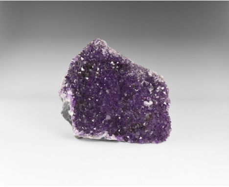 A mass of rich purple amethyst crystals on a sheet of layered blue-grey and white agate, from Brazil. See Bonewitz, Dr. Ronal