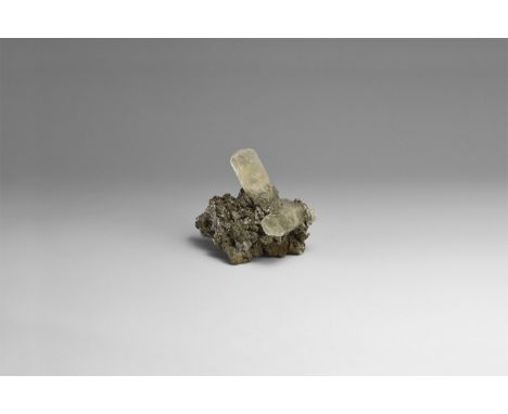 A fine matrix with chalcopyrite and two hexagonal crystals of calcite, in white card box with label reading: 'CALCITE w. CHAL