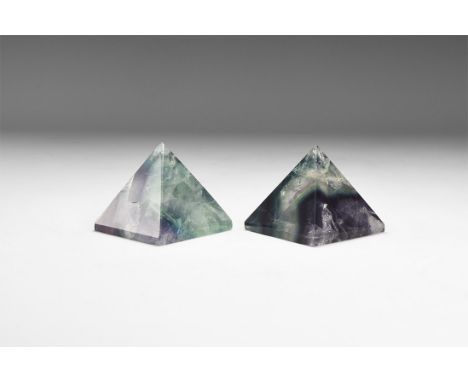 A group of two cut and polished pyramids of fluorite displaying green and purple crystal colour with rainbow reflections. 192