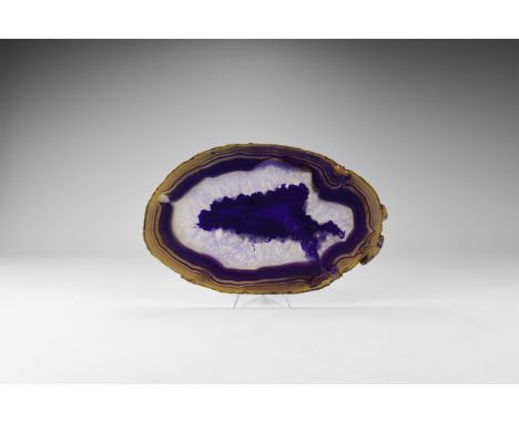 A fine cut and polished agate slice with brown and blue bands, and honeycomb crystal formation, colour enhanced. 549 grams, 2