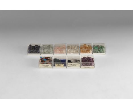 A group of ten plastic display boxes with mineral specimens, including rose quartz, amazonite, citrine, amethyst, quartz, pea