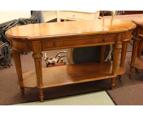 Walnut bow end single drawer console table on turned fluted legs joined by undershelf, 87cm by 157cm.