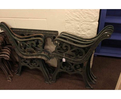 Three pairs of cast garden bench ends and similar pair cast table supports.