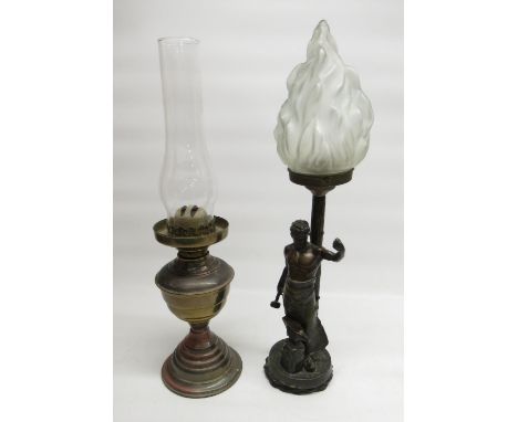 Early c20th bronzed table lamp in the form of a blacksmith, with frosted flame shade and a c20th paraffin lamp, lacking glass