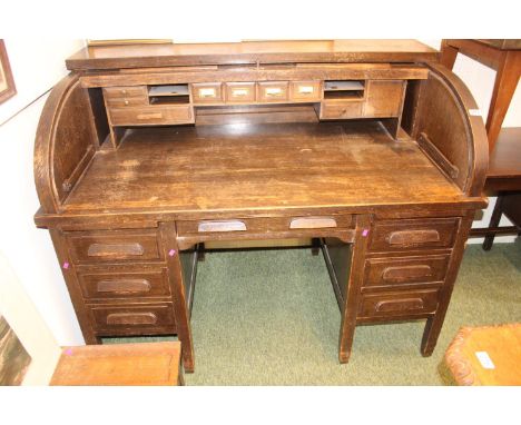 1920s Oak Roll top desk with fitted interior over pedestal base 