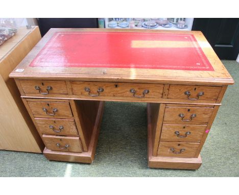 Oak Leather topped pedestal desk of 9 drawers with brass drop handles 