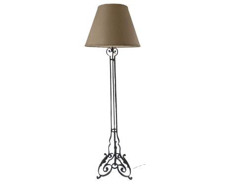 A mid 20th century wrought iron standard lamp
On a scrolling leaf base, with shade, 157cm high including fitting.

Provenance