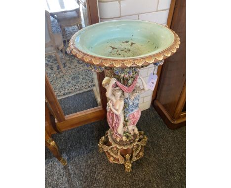 A 19th century majolica polychrome decorated jardiniere
The dished top bordered with floral swags raised on a foliate column 