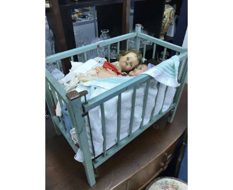 VINTAGE DOLLS IN A PAINTED WOODEN COT 