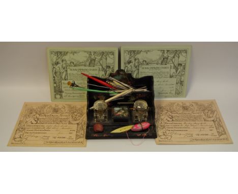 An early 20th century papier mache desk tidy painted with Continental lake scene with two inkwells; various thimbles includin