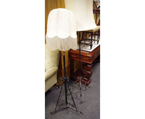 A wrought iron telescopic standard lamp; another wrought iron. (2)