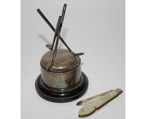 A silver golf trophy raised on ebony plinth base; an early 20th century silver and mother of pearl fruit knife (2) 