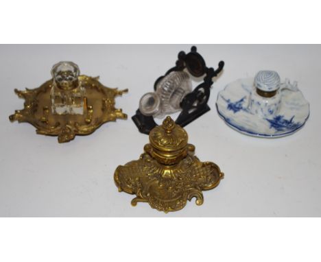 An unusual painted metal chariot inkwell; Etruscan gilt metal pen stand, cherub mounts;another; a ceramic inkwell (4) 