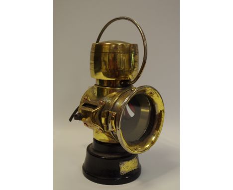 A scarce Lucas King Of The Road No.630 oil-illuminating number plate lamp, brass and black-painted body with flange mounting 