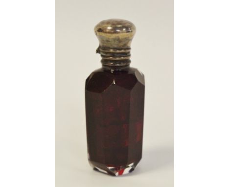 A 19th century silver mounted ruby glass scent bottle, hinged cover enclosing a stopper, c.1880