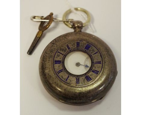 A Victorian silver half-hunter pocket watch, the outer chased with a chapter of Roman numerals picked out in blue enamel, Che