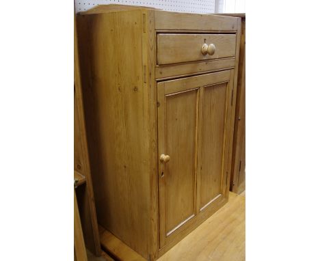An early 20th century pine utility cupboard, shaped gallery, single drawer over panel door cupboard, button handle. 88cm high