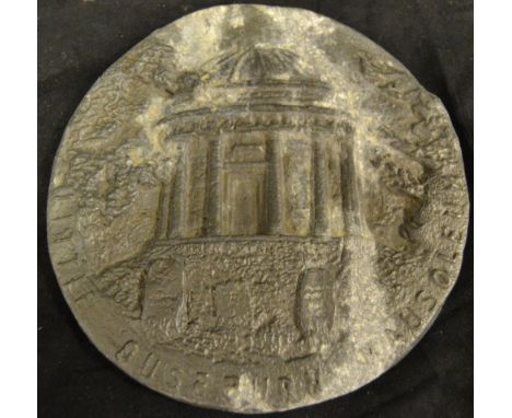 A lead panel of circular form with embossed detail - Little Oustburn Mausoleum (Kirby Hall), detailing a mausoleum flanked by
