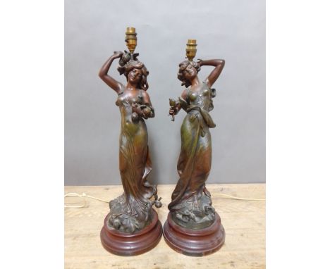 A pair of Art Nouveau patinated spelter lamp bases after Moreau, height 64cm.&nbsp;Condition - one figure missing little fing