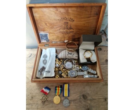 A wooden box containing various items of militaria and collectables including King's Regiment silver ring, King's Regiment si