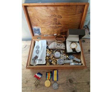 A wooden box containing various items of militaria and collectables including King's Regiment silver ring, King's Regiment si