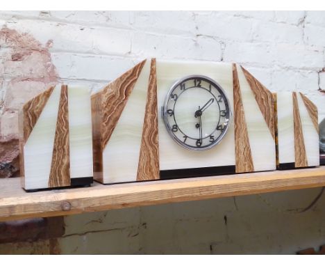 An Art Deco marble mantle clock with garnitures.Condition:- some very small nibbles to edges & corners throughout, winds ok, 