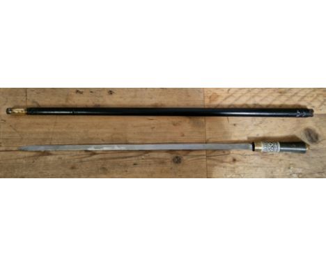 A sword stick with carved bone handle and locking mechanism, ebonised wood with brass tip and brass pommel.  