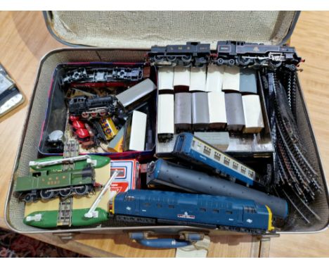 A vintage case containing model railway items, locos, track, rolling stock, etc.