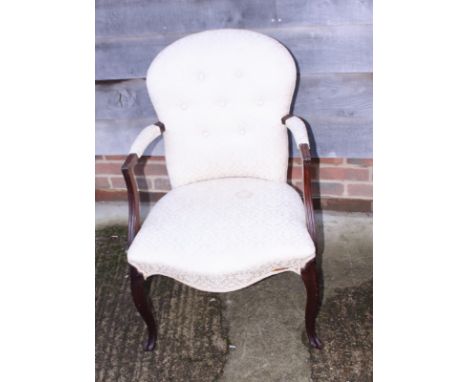 A French late 19th century mahogany open armchair with button upholstered back and stuffed over seat, on cabriole supports