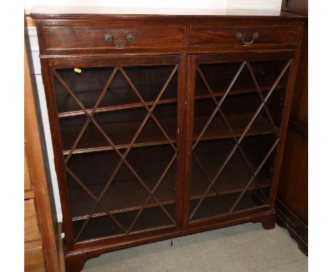 A mahogany bookcase, fitted two drawers over two lattice glazed doors, on bracket feet, 48" wide