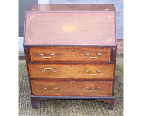 An Edwardian inlaid mahogany fall front bureau, fitted three drawers, on shaped bracket supports, 30" wide