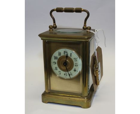 An early 20th century Pearce? &amp; Sons of Paris brass carriage clock with enamelled dial and Arabic numerals, swing carryin