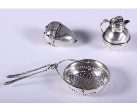A Georgian silver tea strainer, Elizabeth Morley, London 1812, a child's silver rattle, in the form of an acorn, Cornelius De