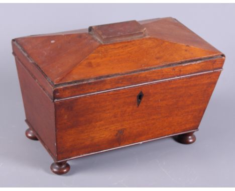 A 19th century mahogany sarcophagus two-division tea caddy, on squat bun feet, together with a Victorian cranberry glass bell