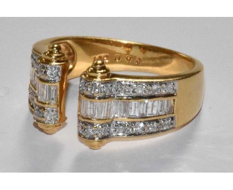 An 18 Carat Gold Diamond Cuff Ring, the yellow plain polished band terminating to rows of baguette cut diamonds flanked by ro