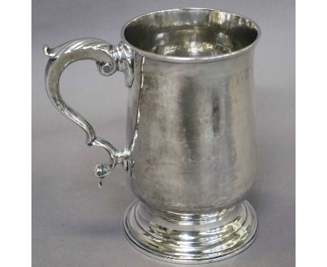 A George III Silver Mug, by Samuel Godbehere and Edward Wigan, London, 1787, baluster and on spreading foot, with leaf-capped