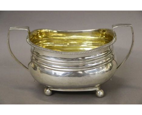 A George III Silver Sugar-Bowl, Maker's Mark Worn, London 1809, oblong and on four ball feet, with gadrooned border and two a