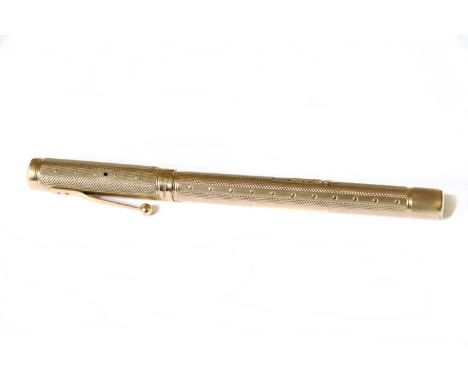 A Gold Waterman's Ideal Fountain Pen, London, 1929, 9ct, with screw cap and overall engine-turned finish, 13.3cm longCase sol