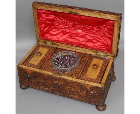 An Ornately Carved Tea Caddy, Victorian, with two compartments and glass mixing bowl, 38cm by 20cm by 23cm