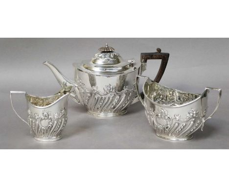 A Three-Piece Victorian Silver Tea-Service, by Charles Stuart Harris, London, 1900, each piece tapering oval, the lower body 