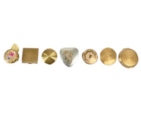 A selection of vintage Kigu compacts, including a heart shaped 'Cherie' example with engine turned decoration and detailing o